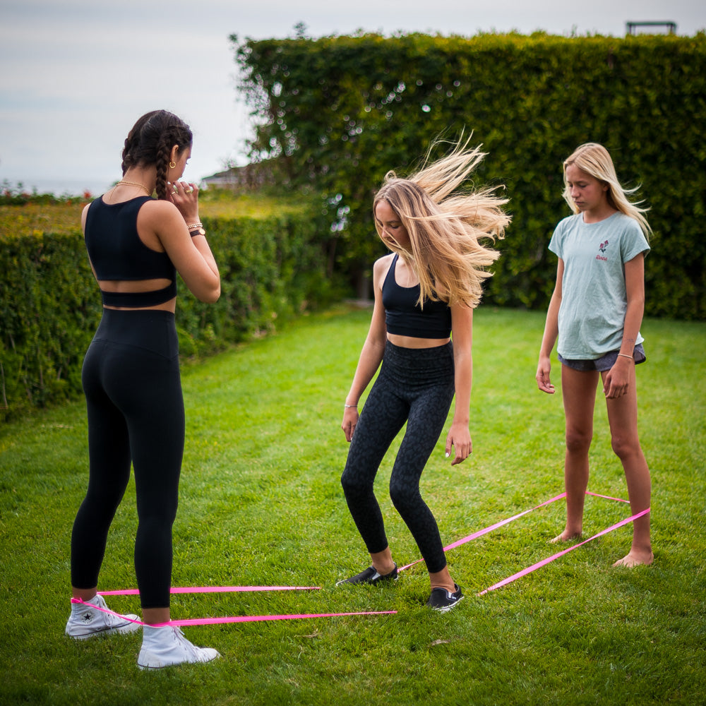 Fun is an understatement! The ATHLETICISM Jump Band is similar to the Chinese Jump Rope. It is a soft, durable, elastic band, while others are rubber. It can be used for all ages. It is best used with two friends with the band around their legs as the third person jumps. 