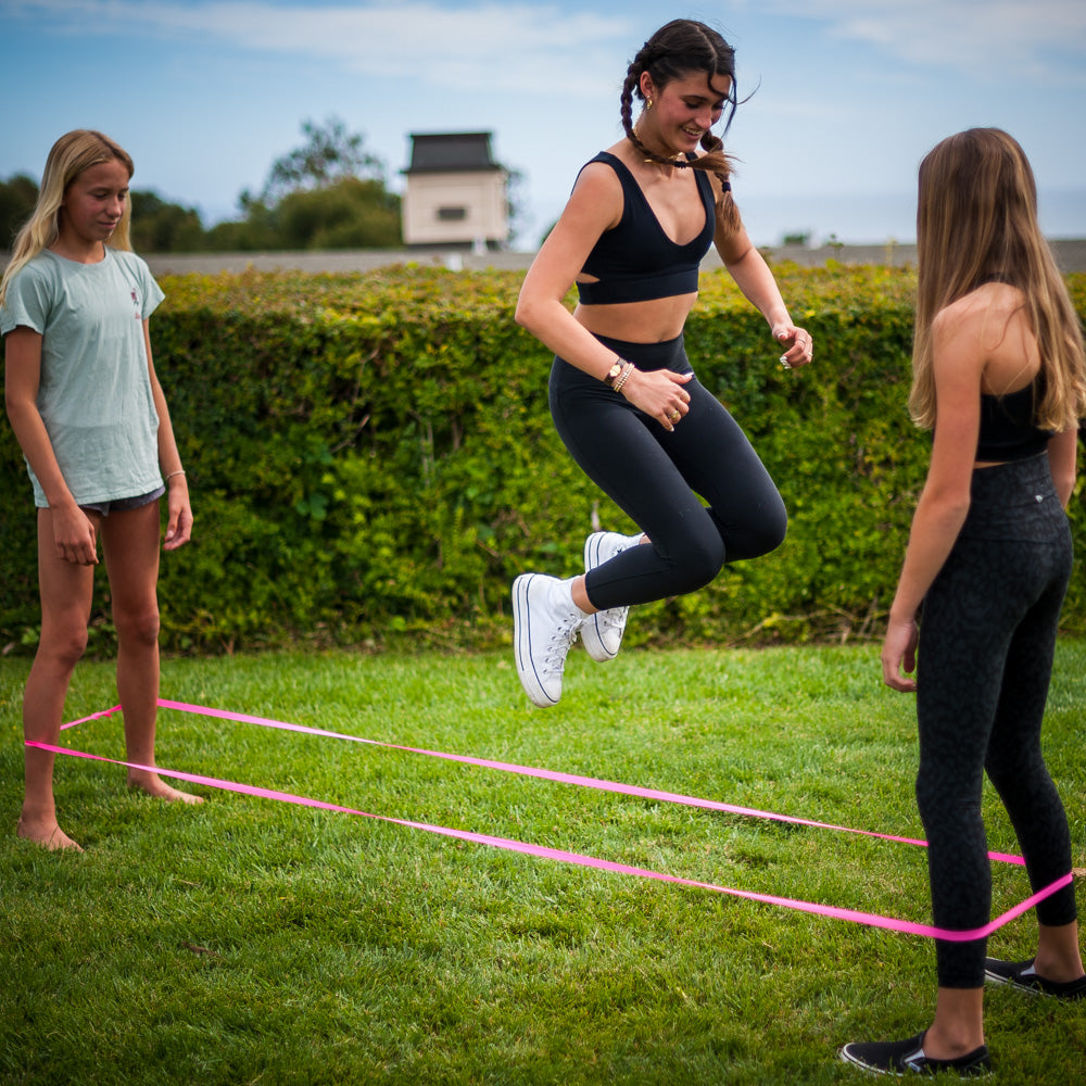 Fun is an understatement! The ATHLETICISM Jump Band is similar to the Chinese Jump Rope. It is a soft, durable, elastic band, while others are rubber. It can be used for all ages. It is best used with two friends with the band around their legs as the third person jumps. 